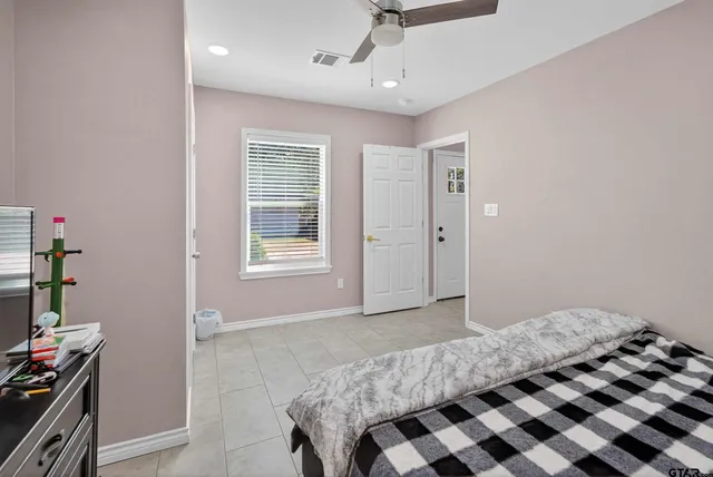 a bedroom with a bed and a window