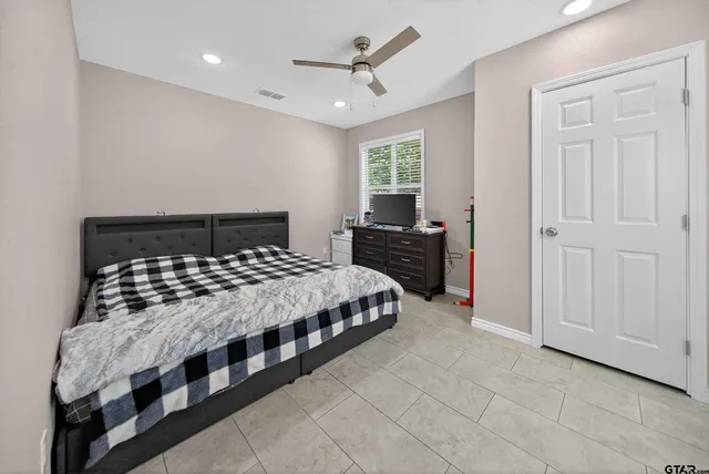 a bedroom with a bed and a window