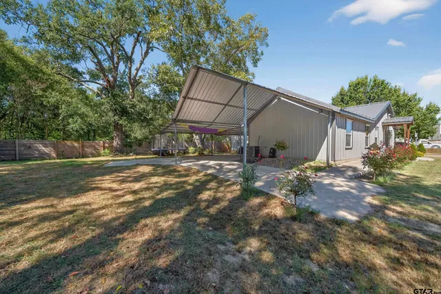 a backyard of a house with table and chairs
