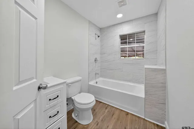 a bathroom with a toilet a sink and bathtub