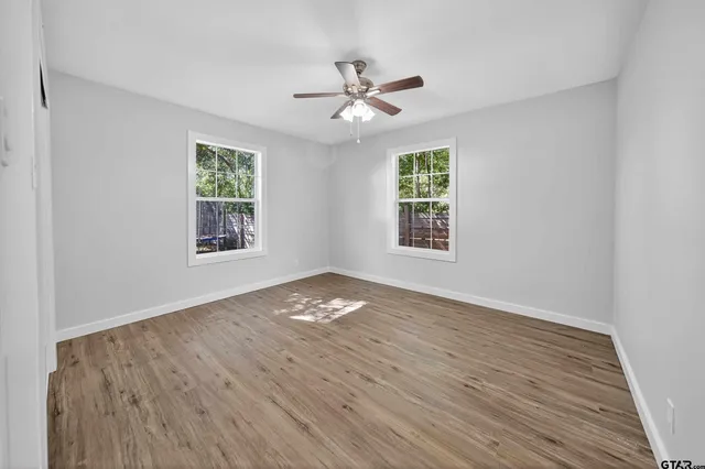 wooden floor in an empty room with a window