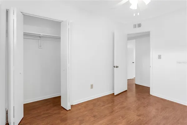 an empty room with closet and a bathroom space