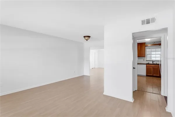 a view of a kitchen with a sink and a refrigerator