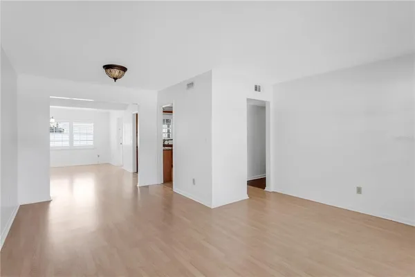 a view of a hallway with wooden floor and closet area