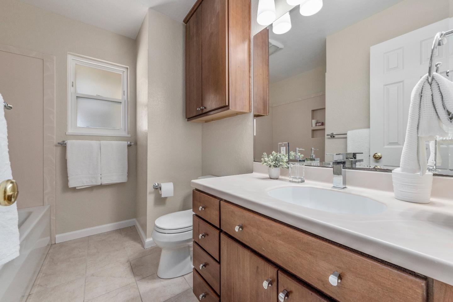 20044 Pacifica Drive Cupertino, CA 95014 - Photo 17 of 23 a bathroom with a sink a toilet and a mirror