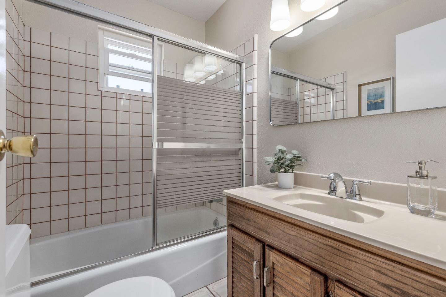 20044 Pacifica Drive Cupertino, CA 95014 - Photo 20 of 23 a bathroom with a granite countertop sink a toilet and shower