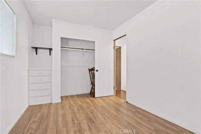 a bedroom with a bed table and a window