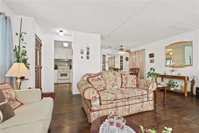 a view of a a dining room with furniture window and wooden floor