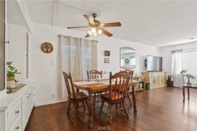 a living room with furniture a dining table and kitchen view