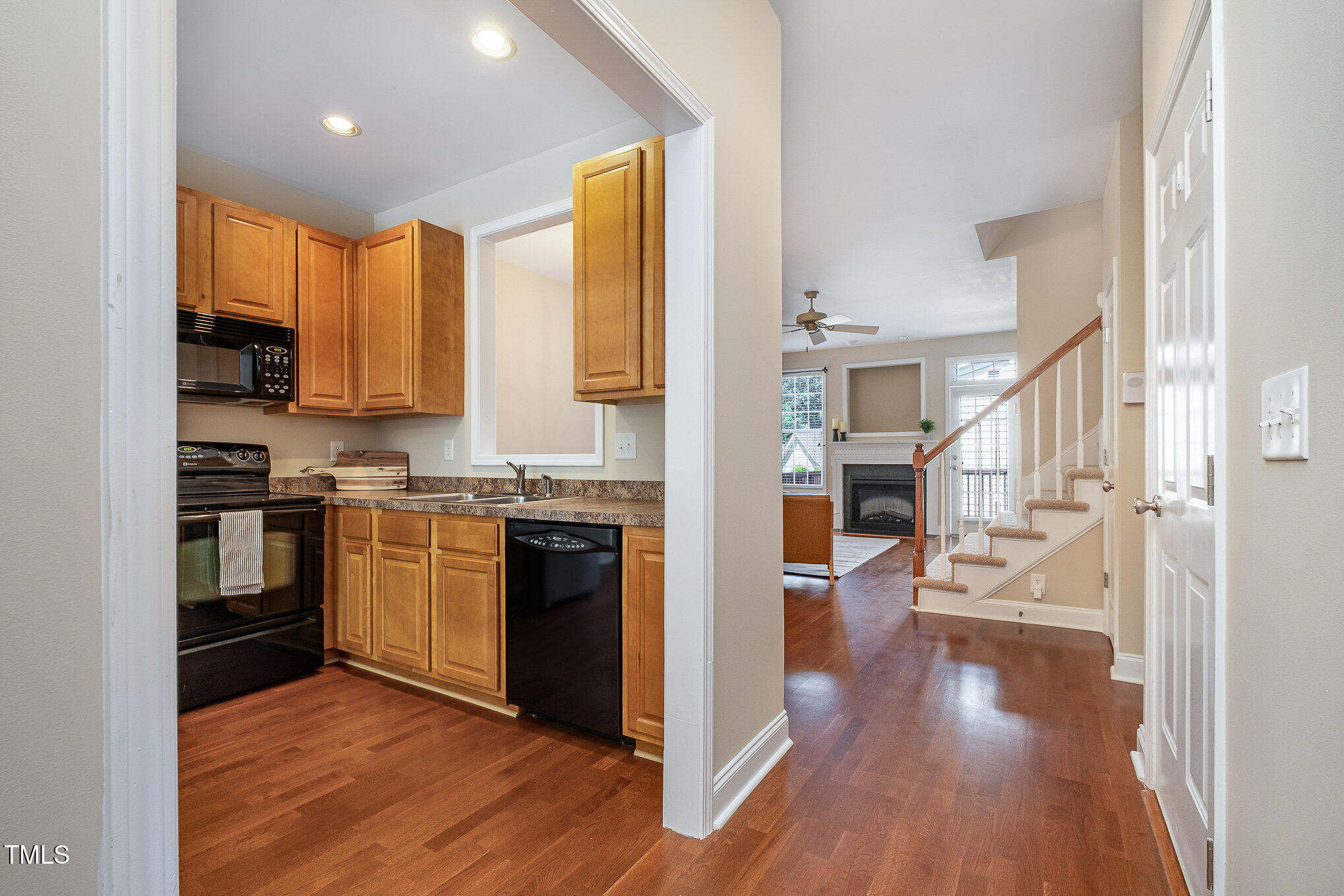 33 Grapevine Trail Durham, NC 27707 - Photo 10 of 30 a kitchen with a refrigerator a stove top oven and wooden floor