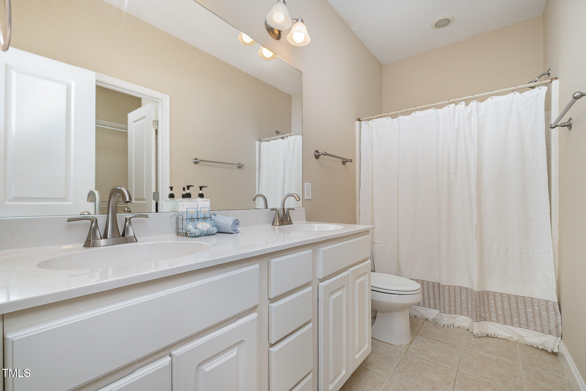 33 Grapevine Trail Durham, NC 27707 - Photo 15 of 30 a bathroom with a double vanity sink toilet and a mirror