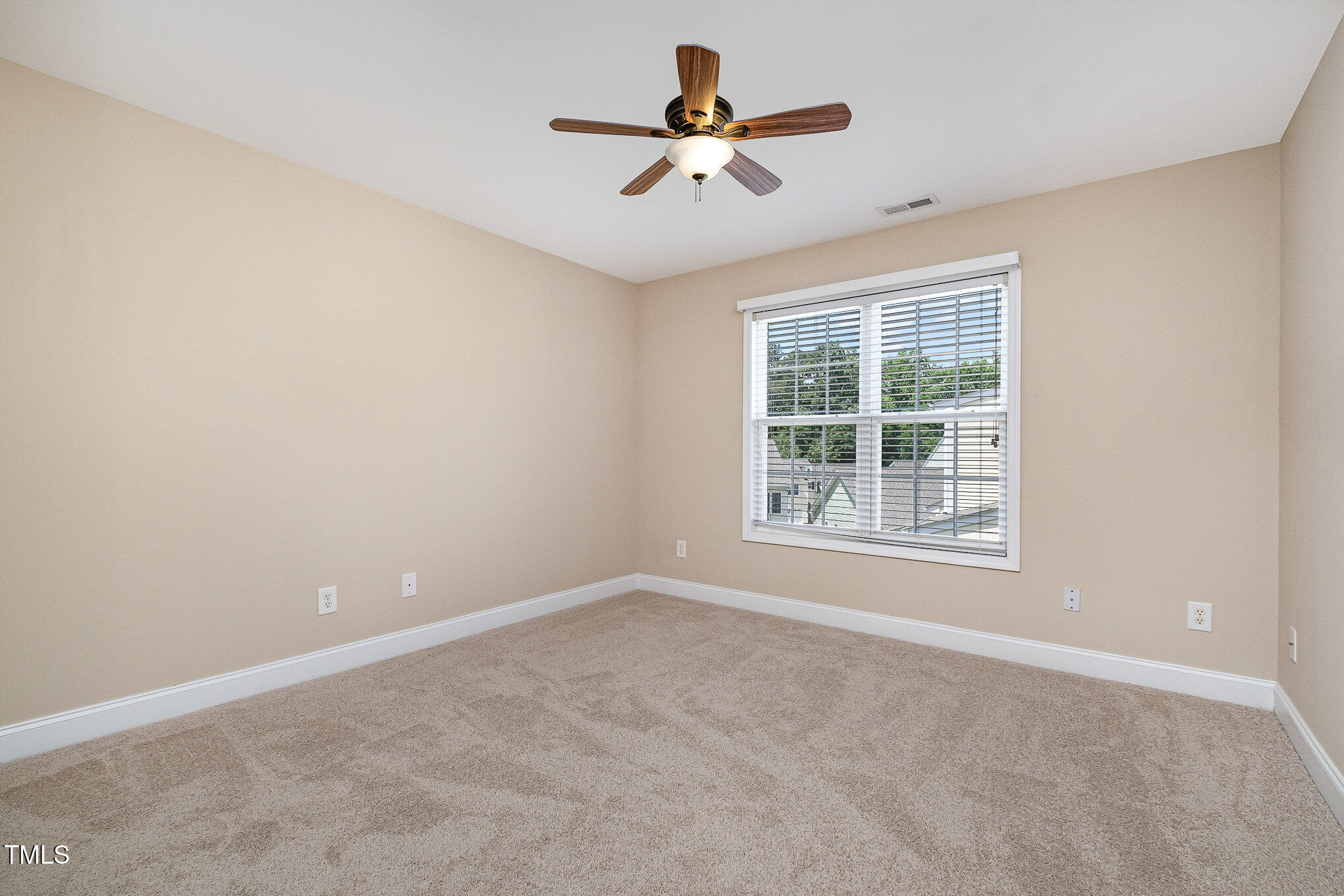33 Grapevine Trail Durham, NC 27707 - Photo 17 of 30 an empty room with a window and a fan