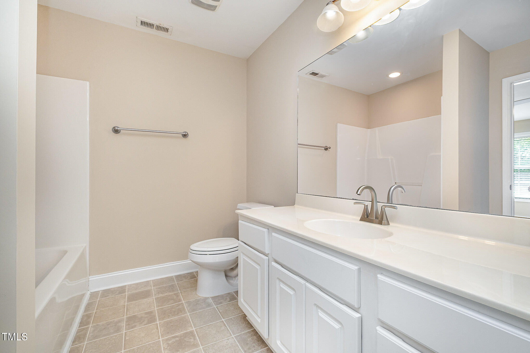 33 Grapevine Trail Durham, NC 27707 - Photo 19 of 30 a bathroom with a sink a toilet and a mirror