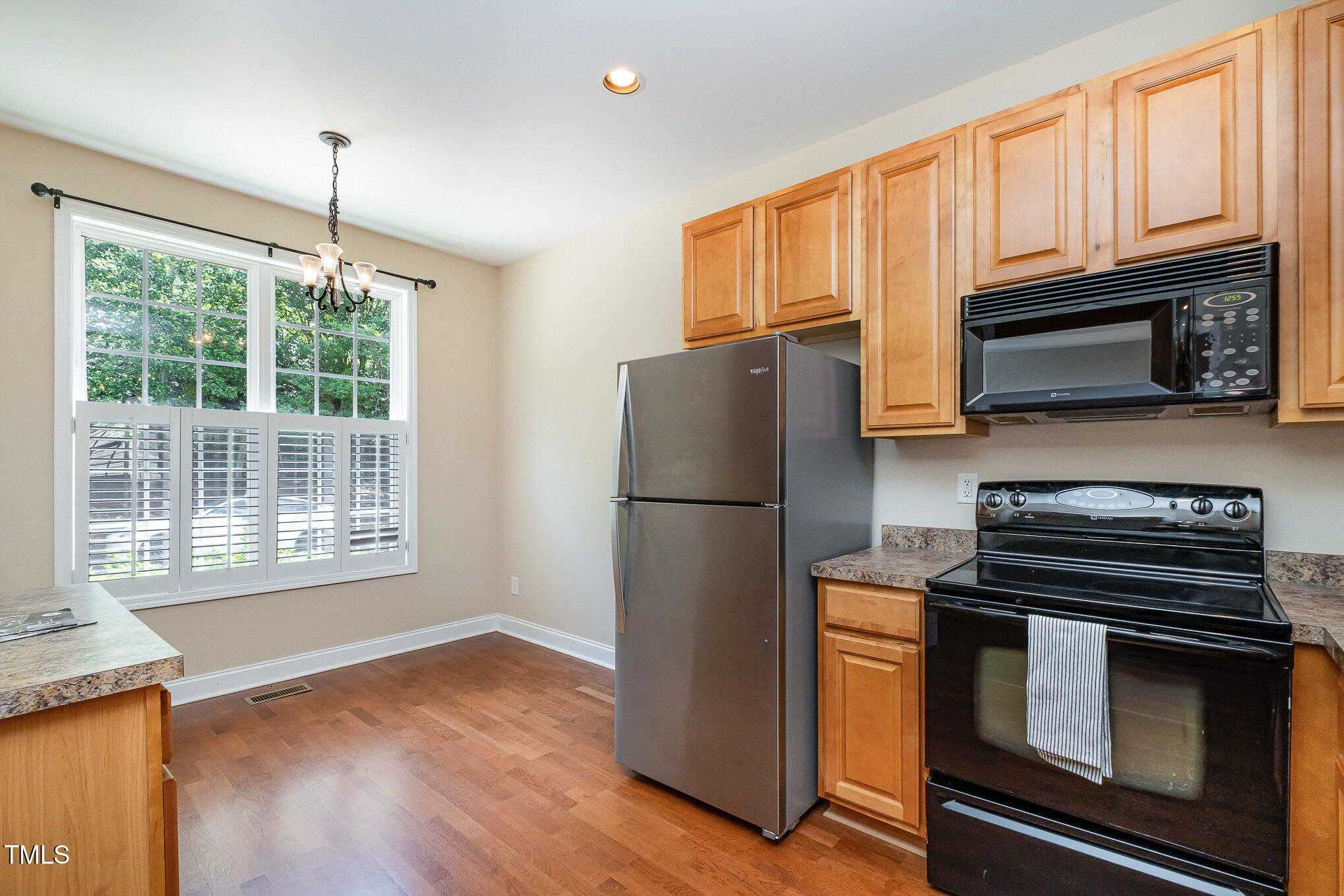 33 Grapevine Trail Durham, NC 27707 - Photo 3 of 30 a kitchen with granite countertop a refrigerator and a stove top oven