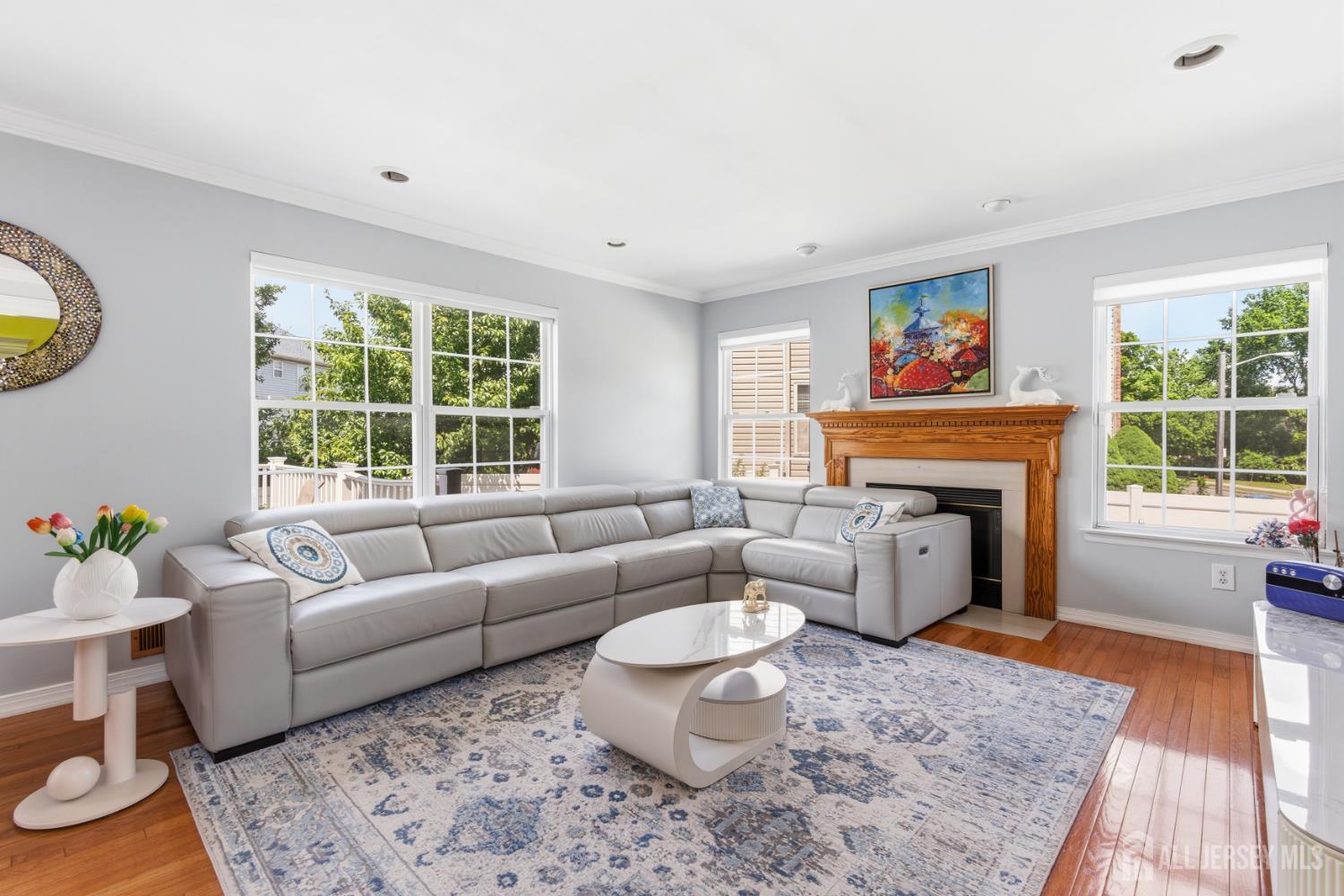 26 Alexis Lane Edison, NJ 08820 - Photo 8 of 39 a living room with furniture a fireplace and a floor to ceiling window
