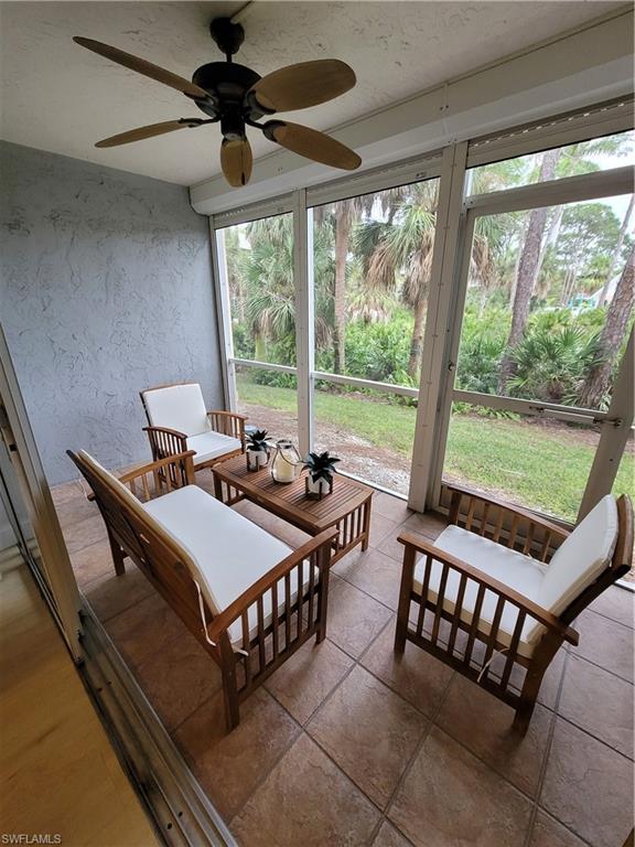 3012 Sandpiper Bay Circle, Unit D102 Naples, FL 34112 - Photo 11 of 13 a view of a dining room with furniture window and outside view