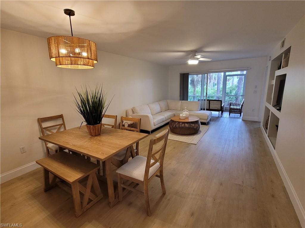 3012 Sandpiper Bay Circle, Unit D102 Naples, FL 34112 - Photo 4 of 13 a dining room with furniture window and wooden floor