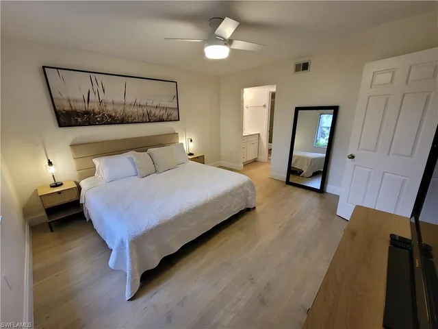 a bedroom with a bed and a mirror