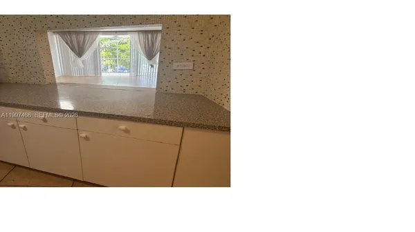 a kitchen with cabinets and white appliances