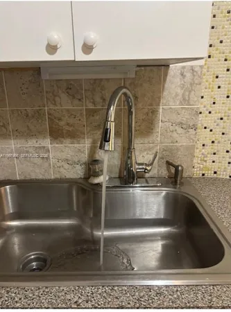 a bathroom with a shower a toilet and a sink