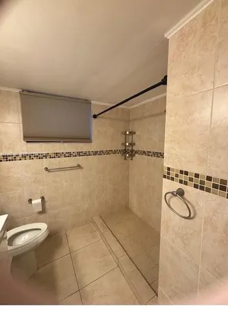 a bathroom with a sink mirror and shower
