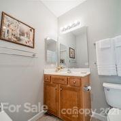 265 Garnet Court, Unit 550 Fort Mill, SC 29708 - Photo 14 of 41 a spacious bathroom with a toilet sink and mirror