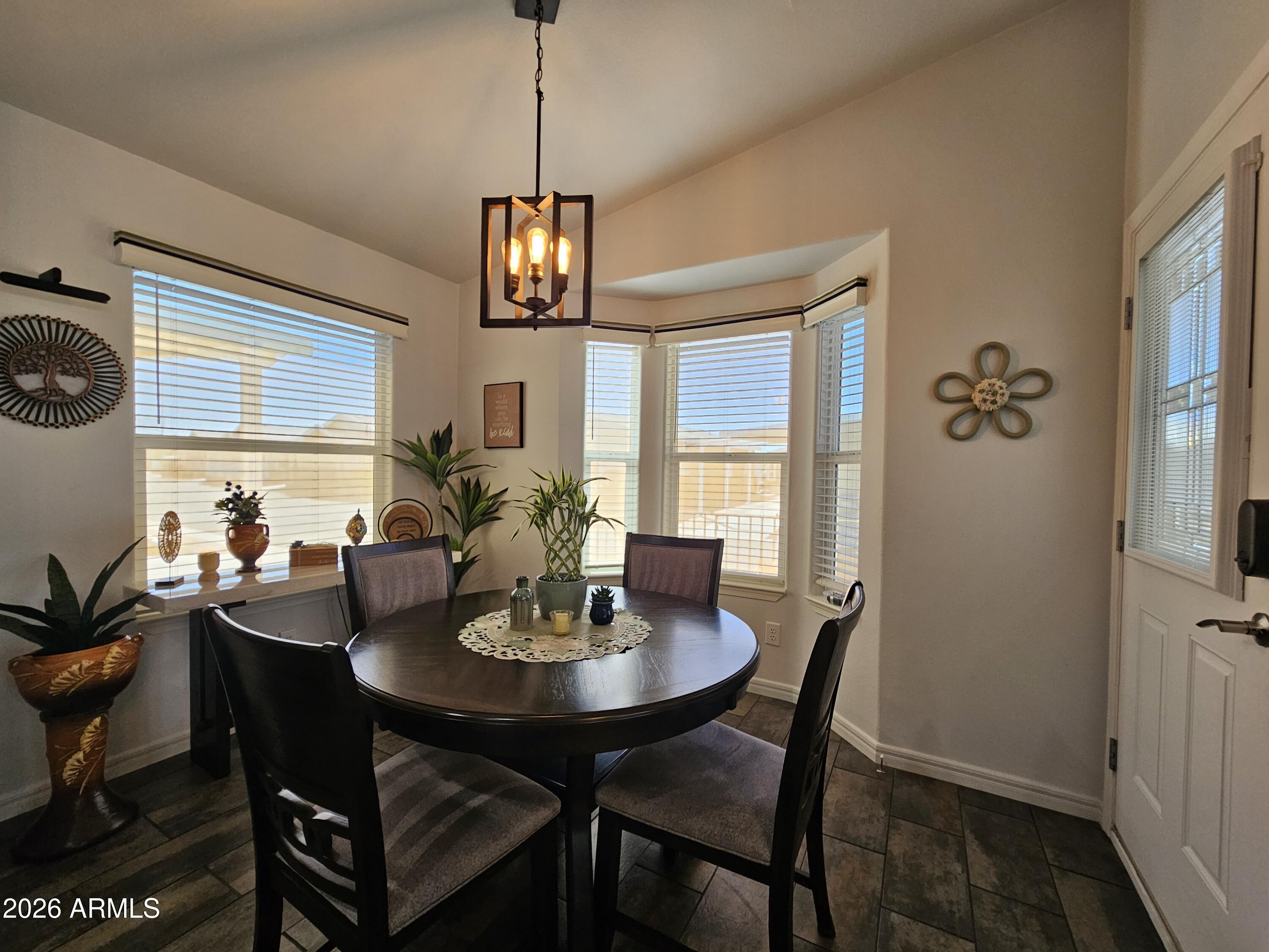 650 North Hawes Road, Unit 3406 Mesa, AZ 85207 - Photo 11 of 45 a view of a dining room with furniture window and wooden floor