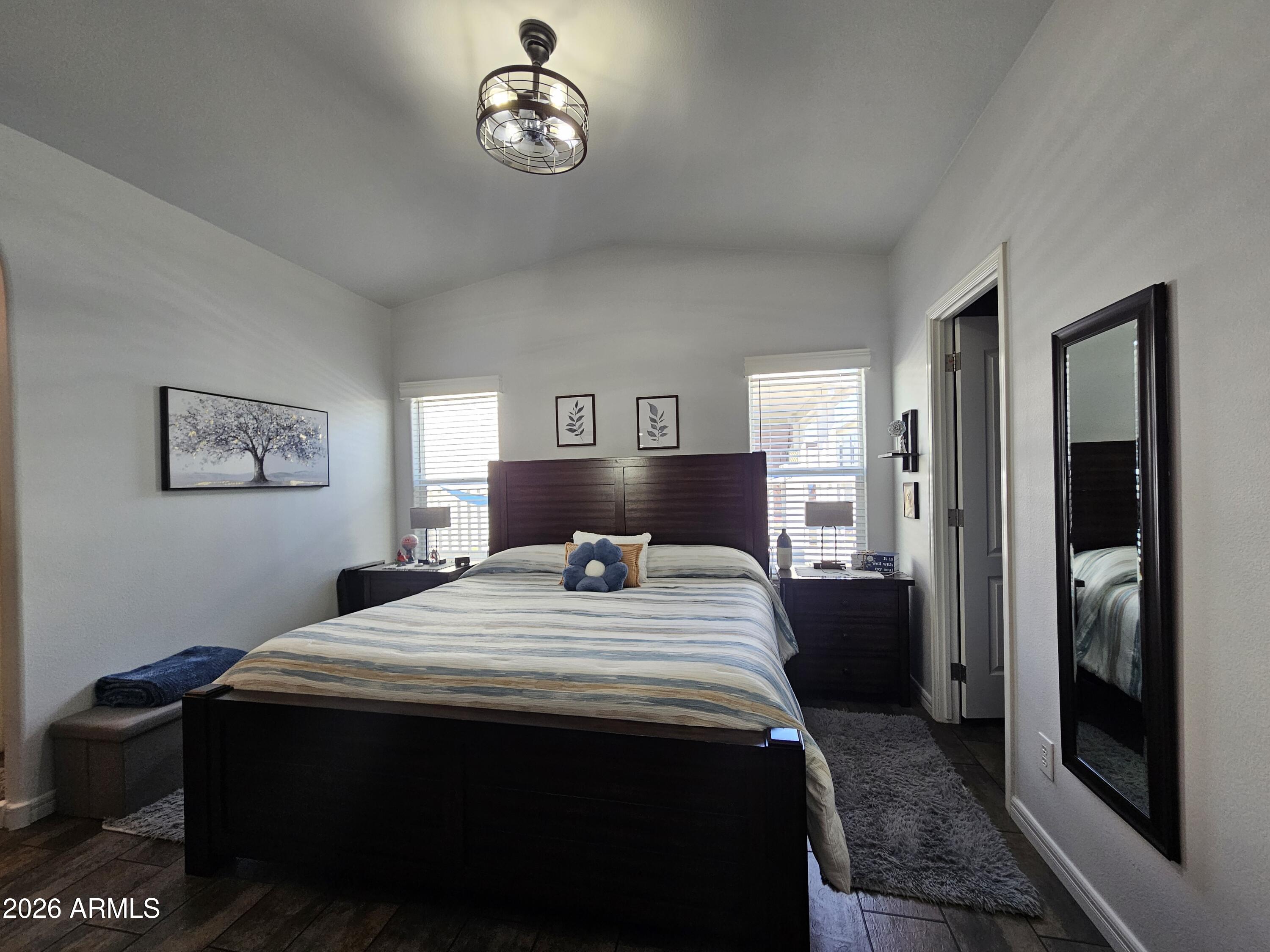 650 North Hawes Road, Unit 3406 Mesa, AZ 85207 - Photo 13 of 45 a bedroom with a bed and a table in it