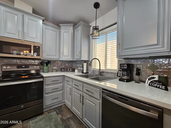 a living room with furniture a chandelier and a window
