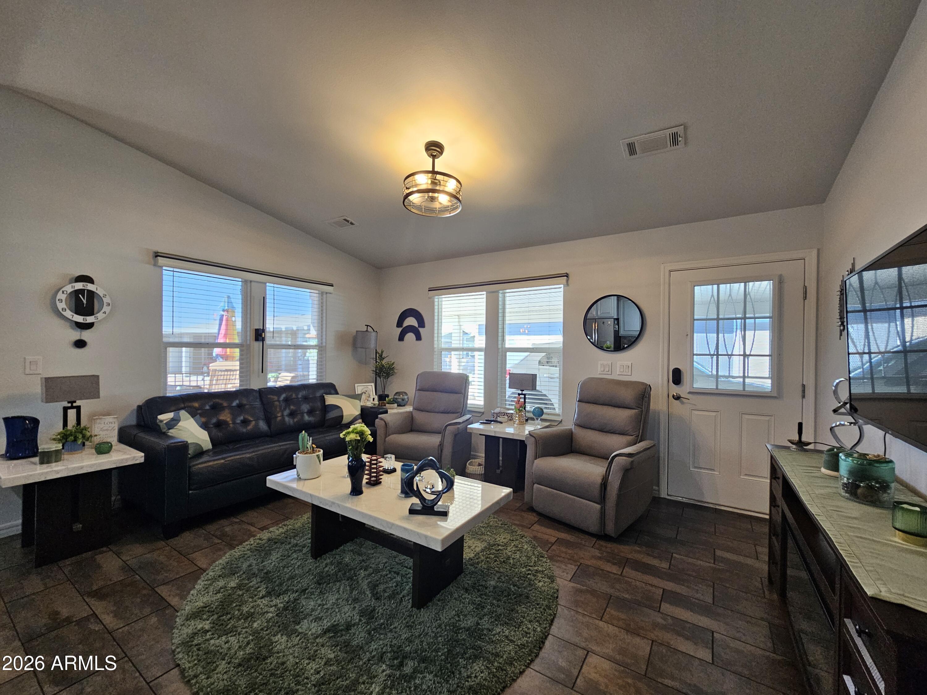 650 North Hawes Road, Unit 3406 Mesa, AZ 85207 - Photo 17 of 45 a living room with furniture a chandelier and a window