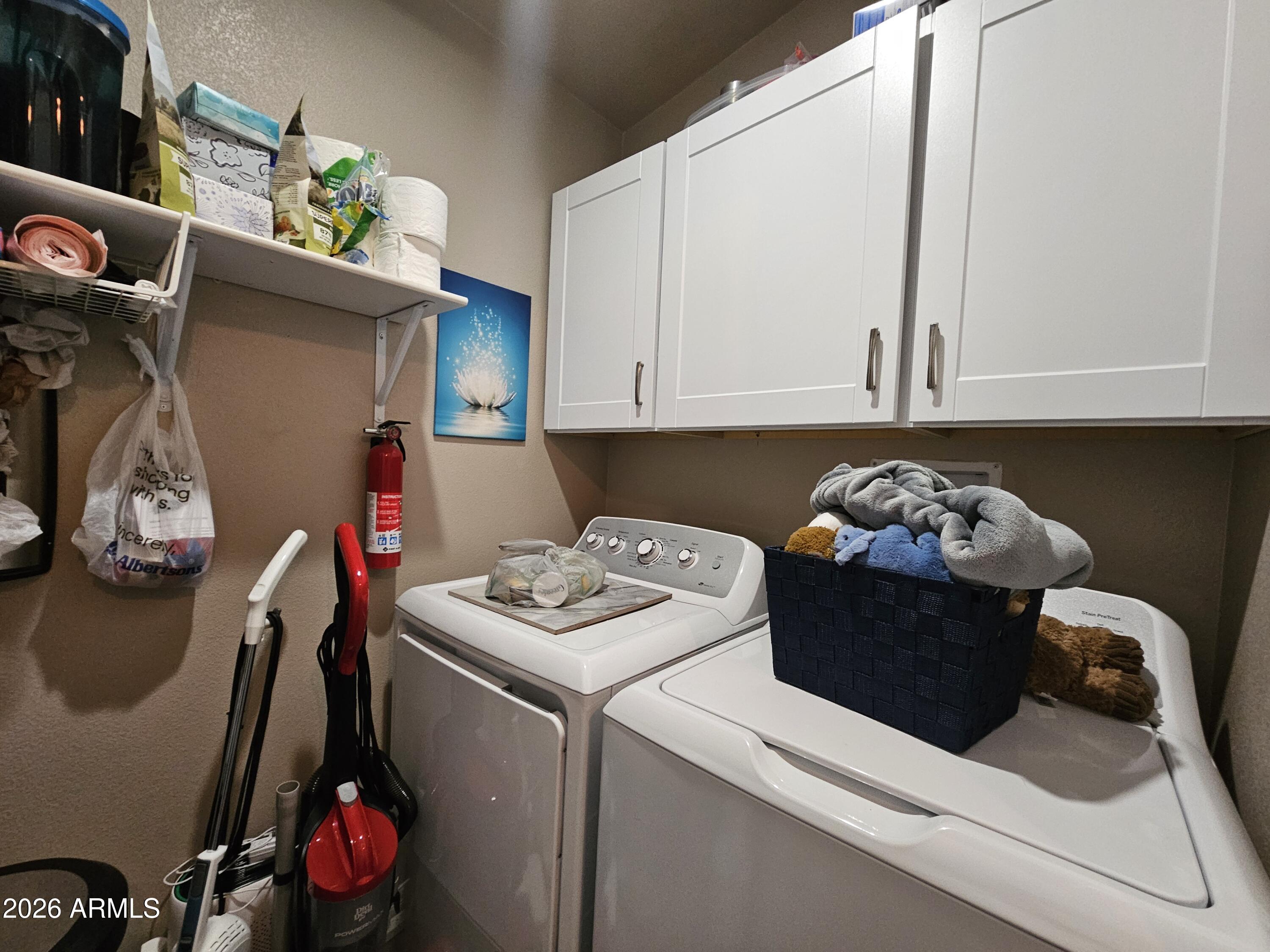 650 North Hawes Road, Unit 3406 Mesa, AZ 85207 - Photo 20 of 45 a kitchen with a refrigerator and cabinets