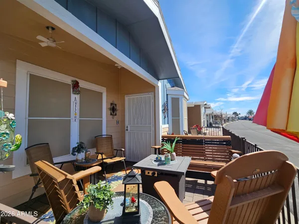 a balcony with furniture and wooden floor