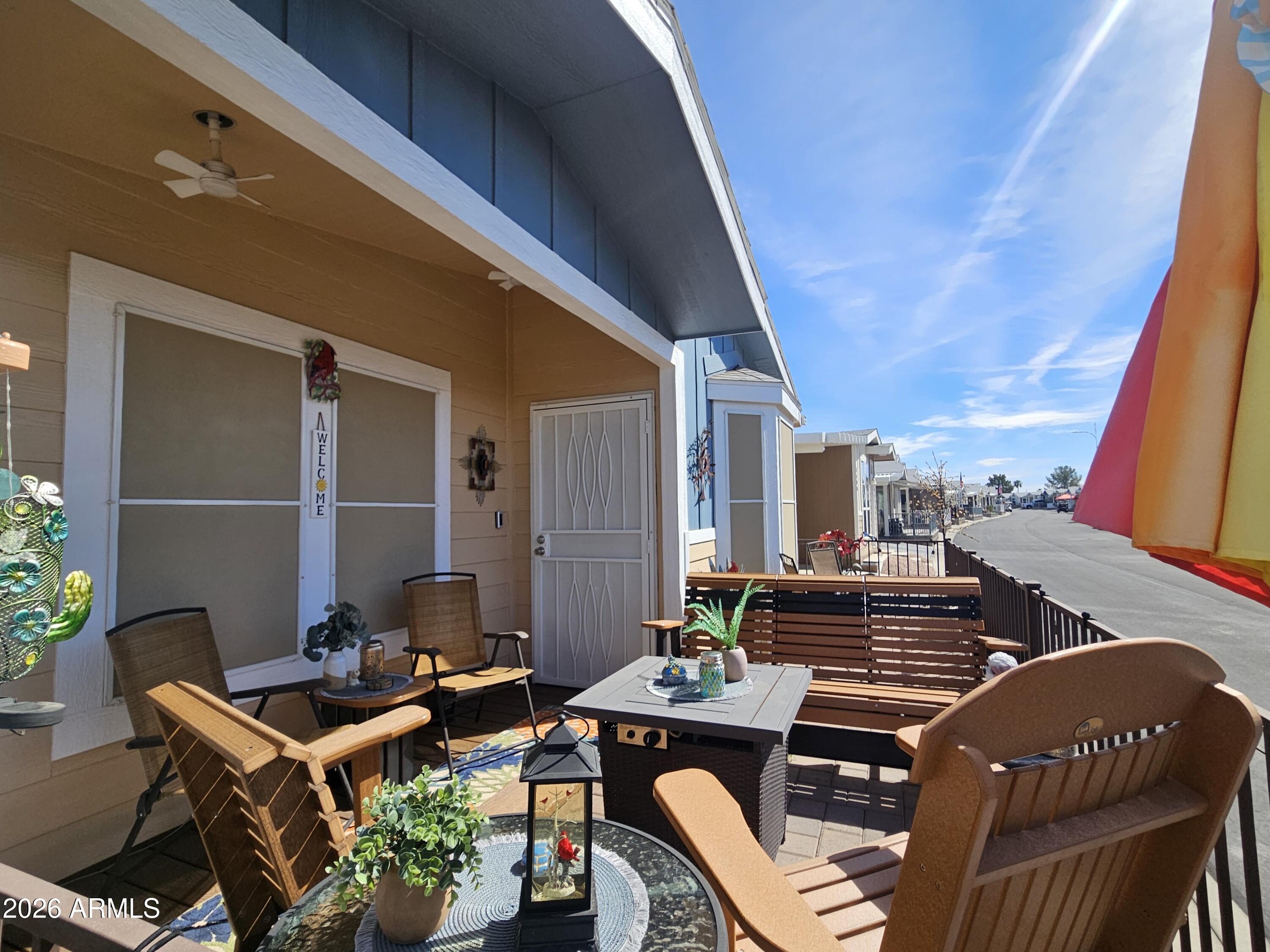 650 North Hawes Road, Unit 3406 Mesa, AZ 85207 - Photo 2 of 45 a balcony with furniture and wooden floor