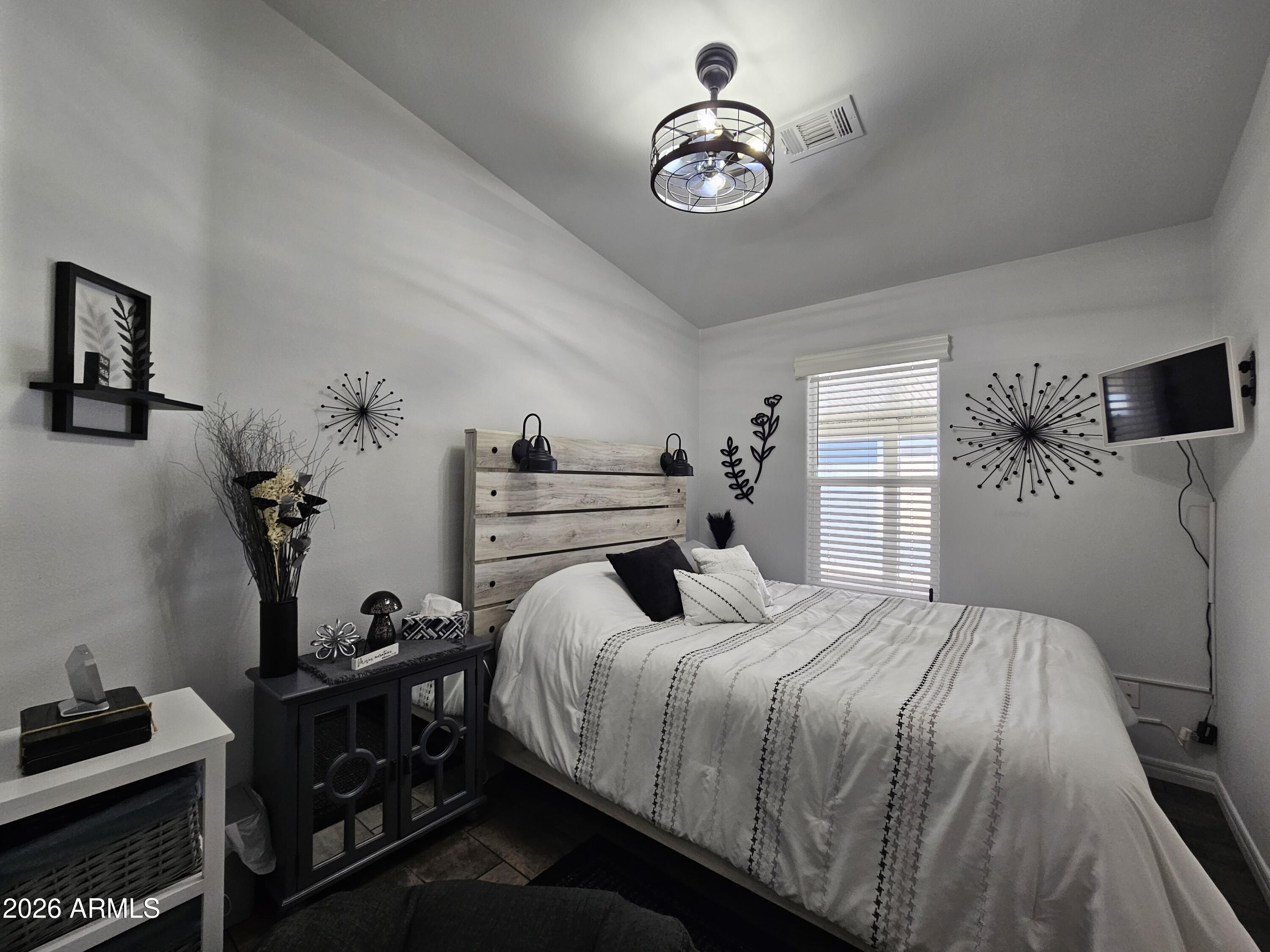 650 North Hawes Road, Unit 3406 Mesa, AZ 85207 - Photo 22 of 45 a bedroom with a bed and a chandelier