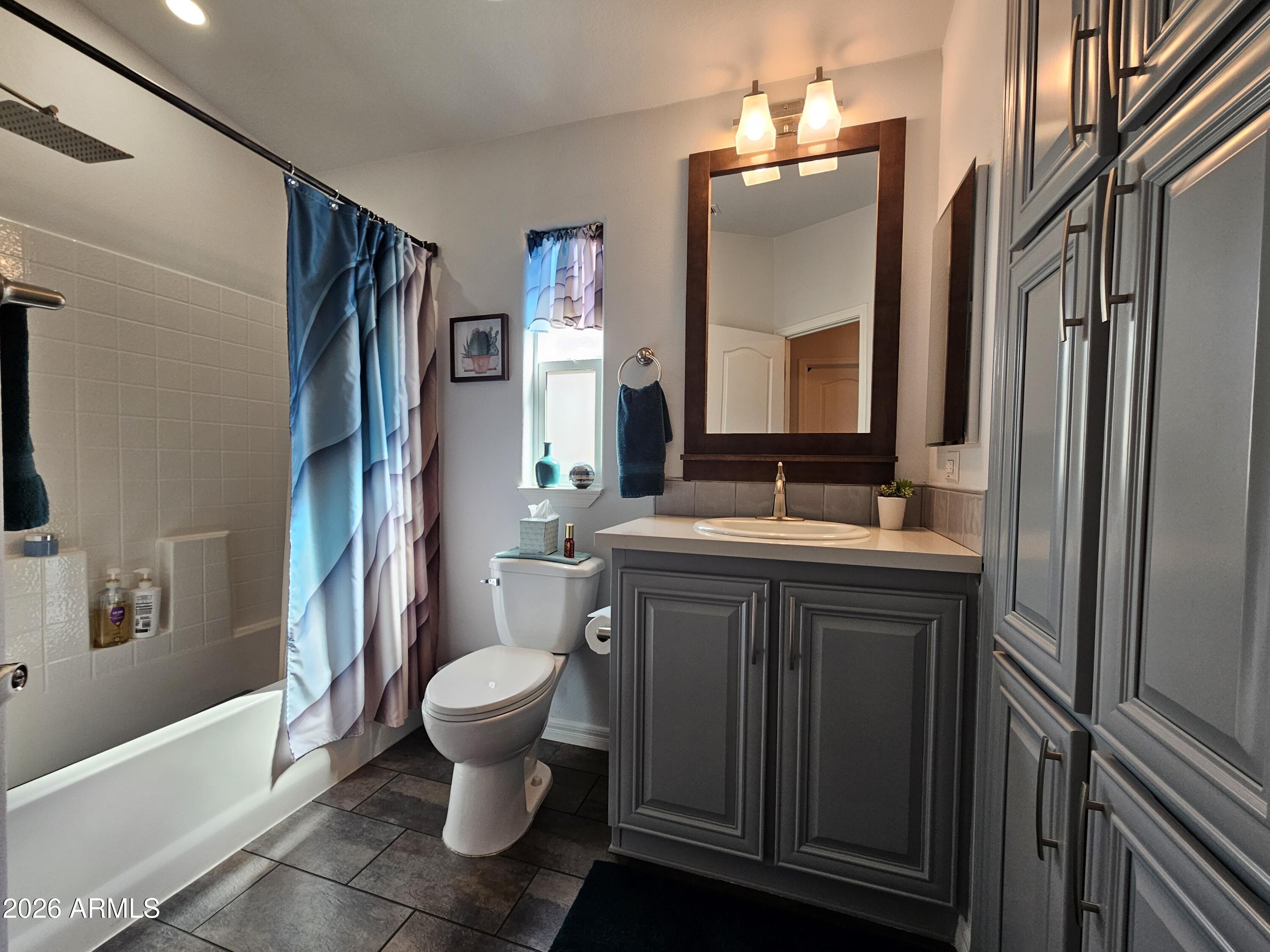 650 North Hawes Road, Unit 3406 Mesa, AZ 85207 - Photo 24 of 45 a bathroom with a double vanity sink toilet and shower
