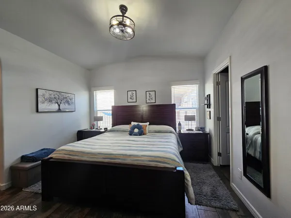 a bedroom with a bed and a chandelier