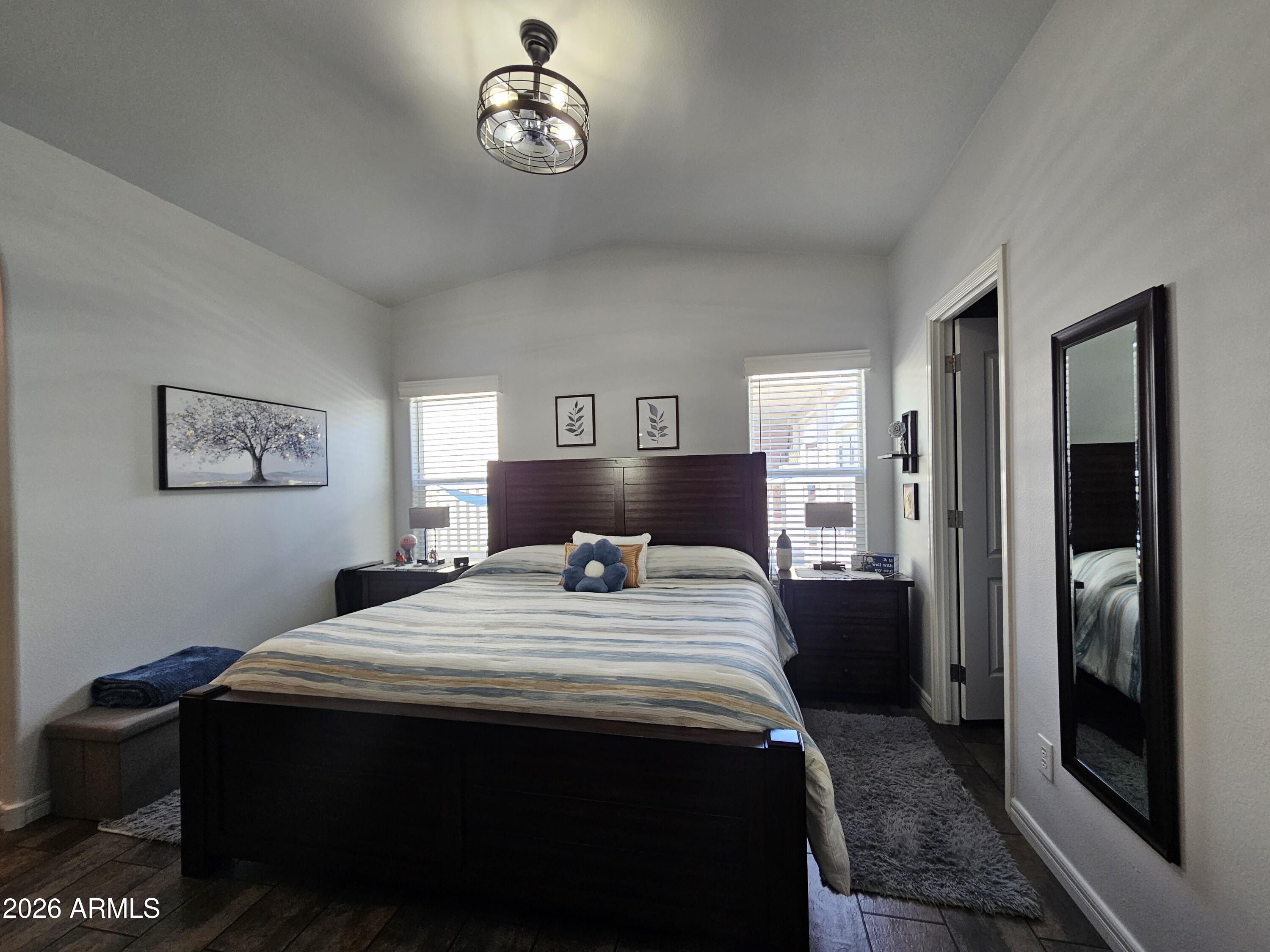 650 North Hawes Road, Unit 3406 Mesa, AZ 85207 - Photo 26 of 45 a bedroom with a bed and a table in it