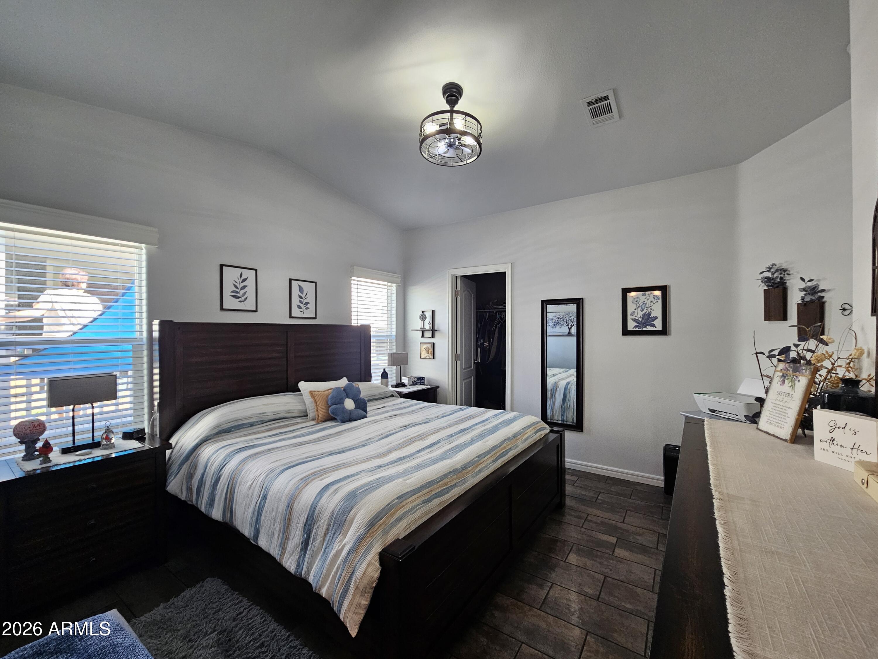 650 North Hawes Road, Unit 3406 Mesa, AZ 85207 - Photo 31 of 45 a bedroom with bed and a chandelier