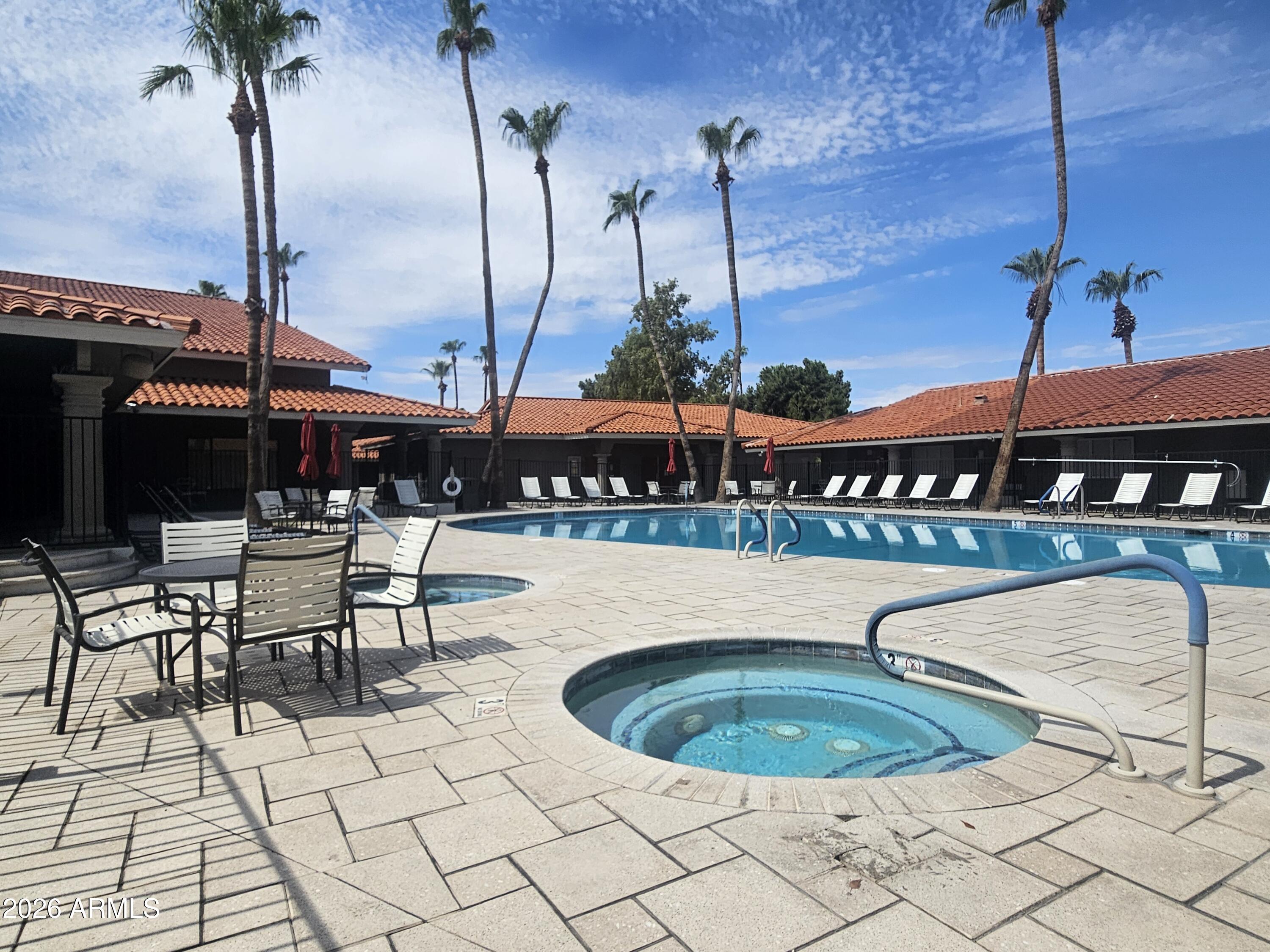 650 North Hawes Road, Unit 3406 Mesa, AZ 85207 - Photo 32 of 45 a table and chairs in the patio with a fountain