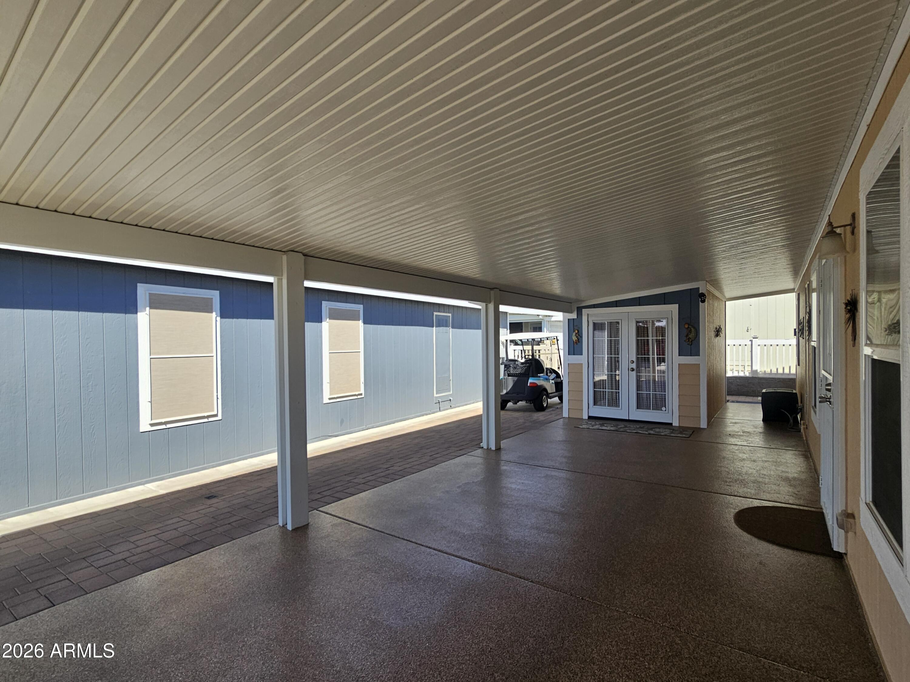 650 North Hawes Road, Unit 3406 Mesa, AZ 85207 - Photo 5 of 45 a view of an empty room with wooden floor and a window