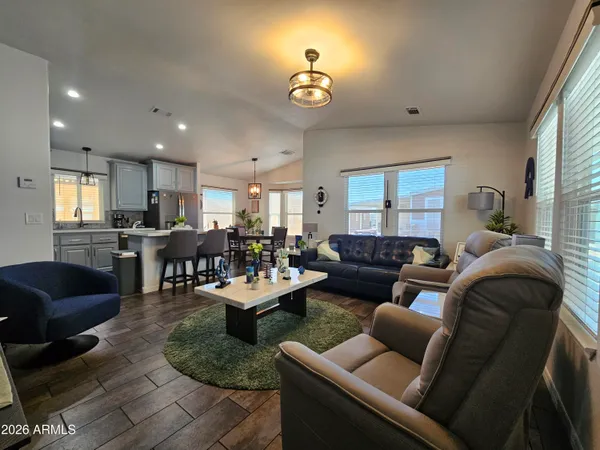 a kitchen with granite countertop stainless steel appliances a refrigerator a stove a sink a dining table and chairs