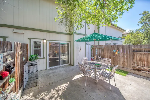 a backyard of a house with yard barbeque oven and outdoor seating