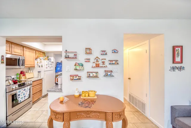 a dining room with a table and chairs