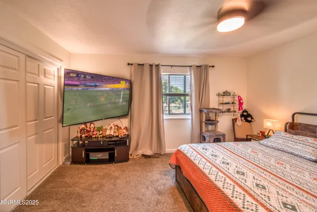 a bed room with a bed and a flat screen tv