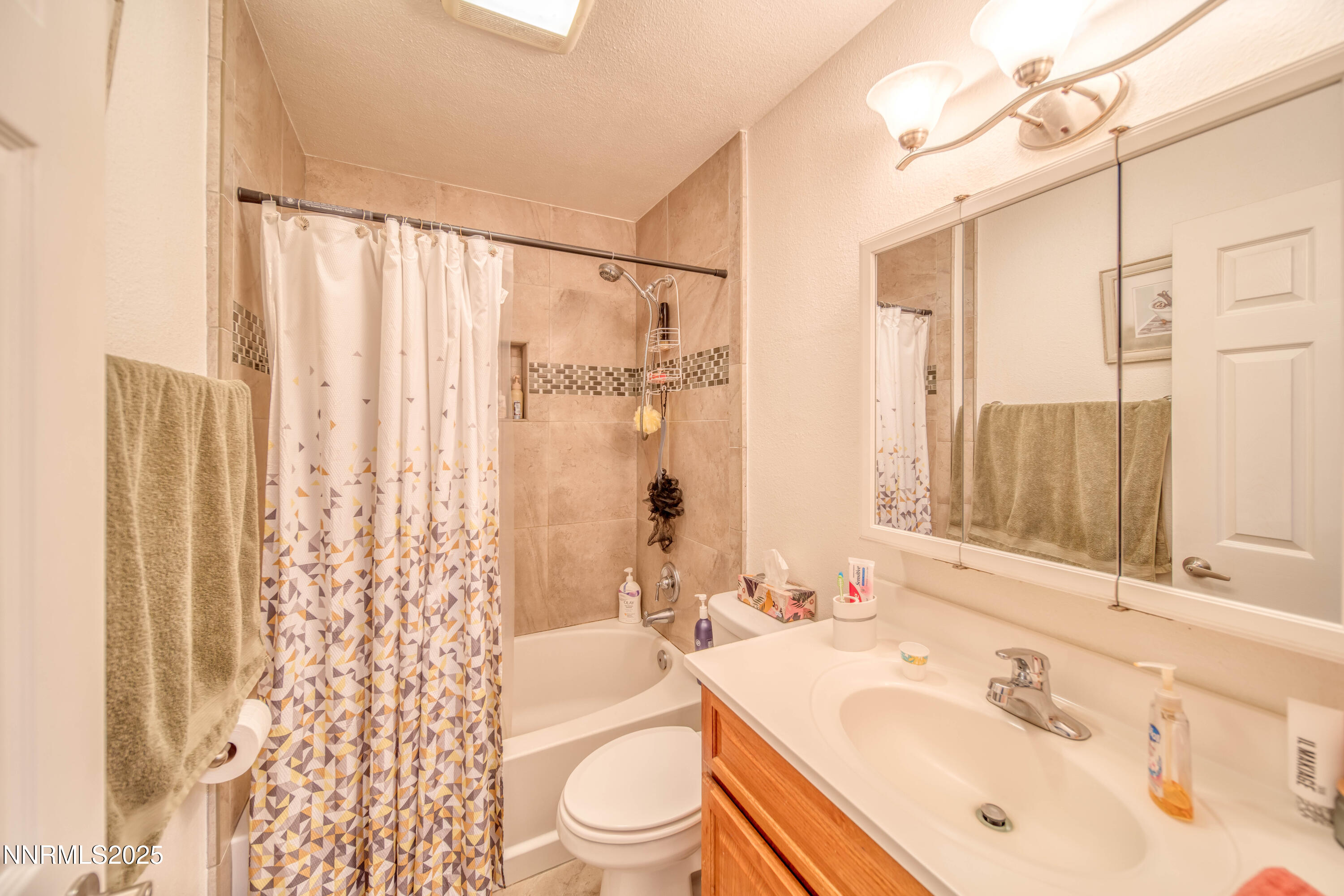 2168 Cannonball Road Sparks, NV 89431 - Photo 10 of 21 a bathroom with a sink a toilet a mirror a bathtub and shower