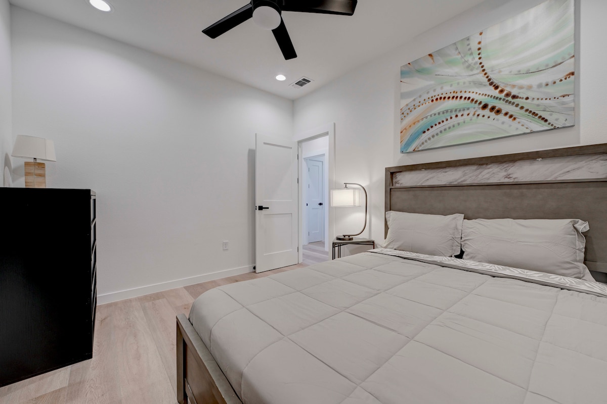 2220 Yellow Jacket Lane, Unit 1 Austin, TX 78741 - Photo 17 of 35 Recessed lighting illuminates this inviting bedroom, featuring a contemporary ceiling fan and light wood flooring.