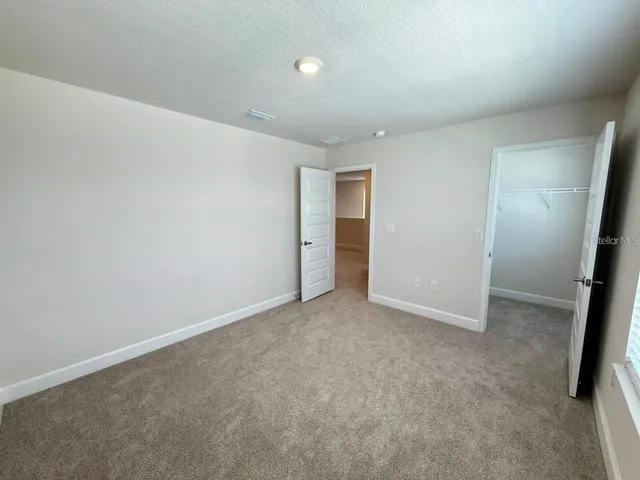 a spacious bathroom with a double vanity sink and a mirror