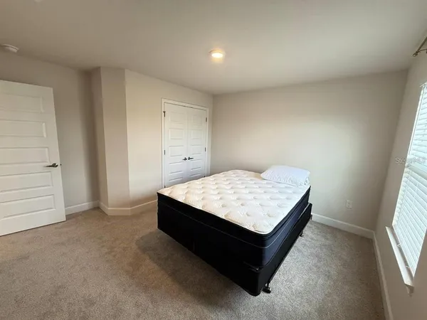 a room with a bed and window