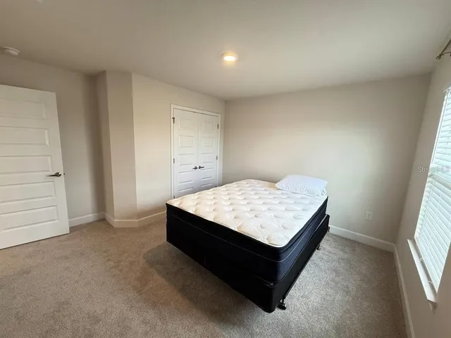 a room with a bed and window