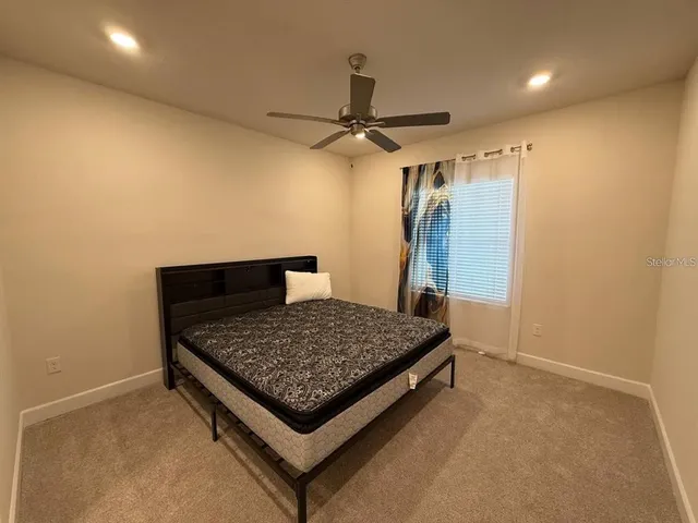 a living room with a bed and a chandelier